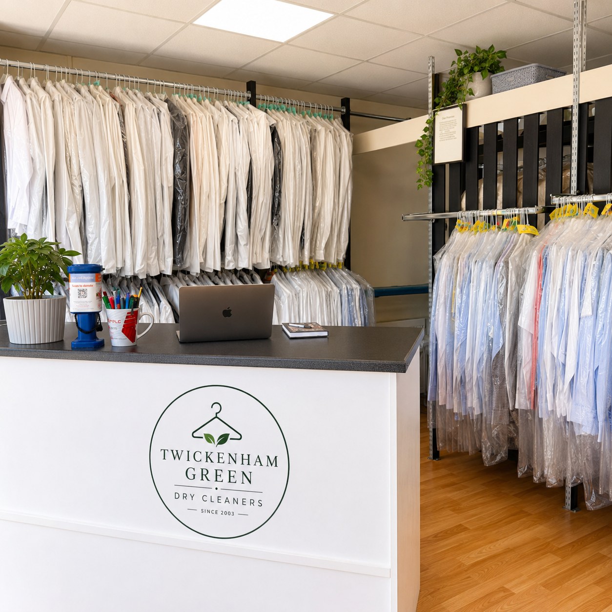 Inside Twickenham Dry Cleaners with professionally covered garments ready for customers